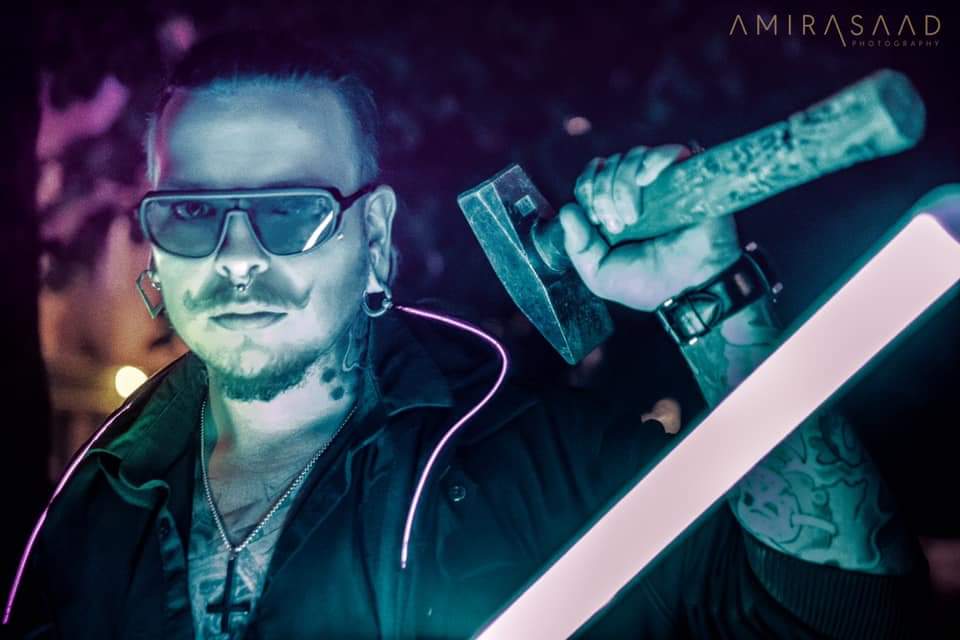 Rosecraft member on stage under neon light